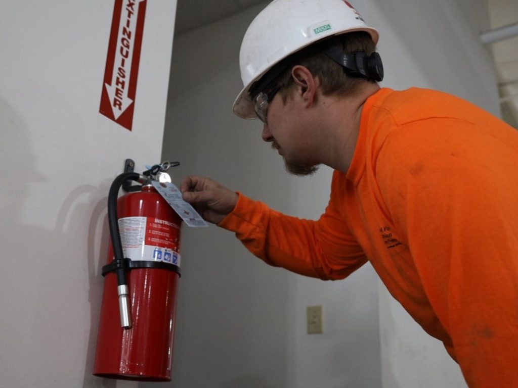 fire extinguisher inspector, inspecting a fire extinguisher, tagging fire extinguisher